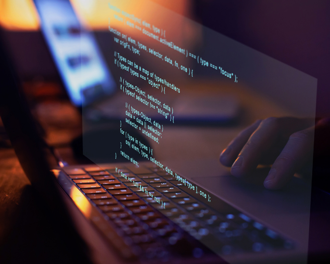 Developer writing code on a laptop to build a custom exam platform