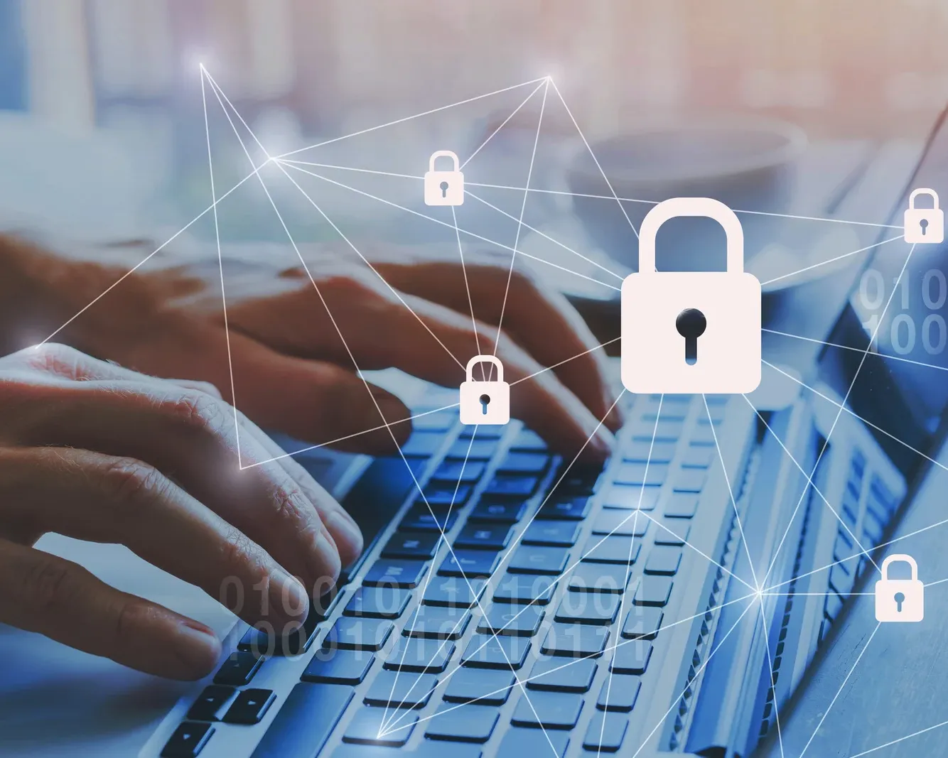"Hands typing on a laptop keyboard with digital padlock icons representing cybersecurity and data protection.