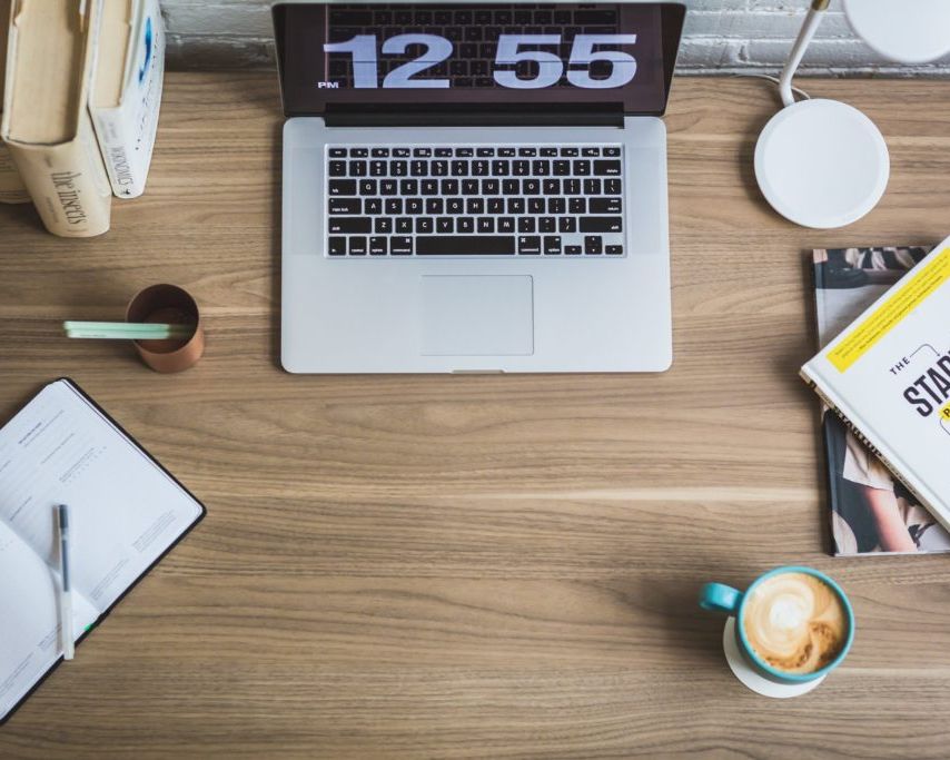 Macbook pro on desk showing a clock
