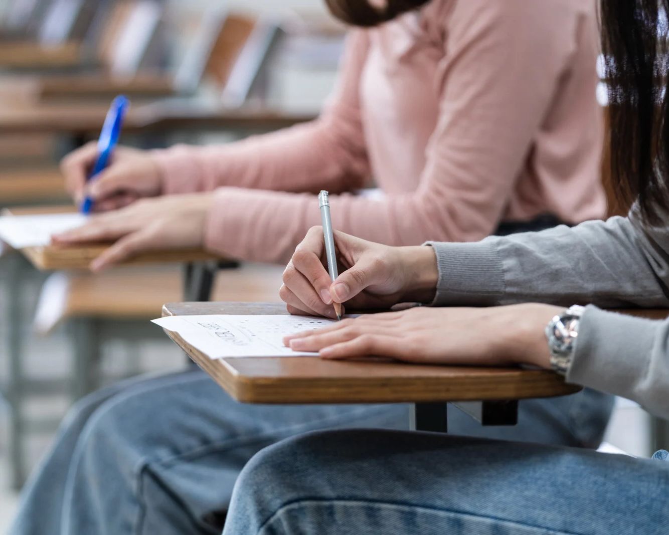 Students writing an exam in a classroom