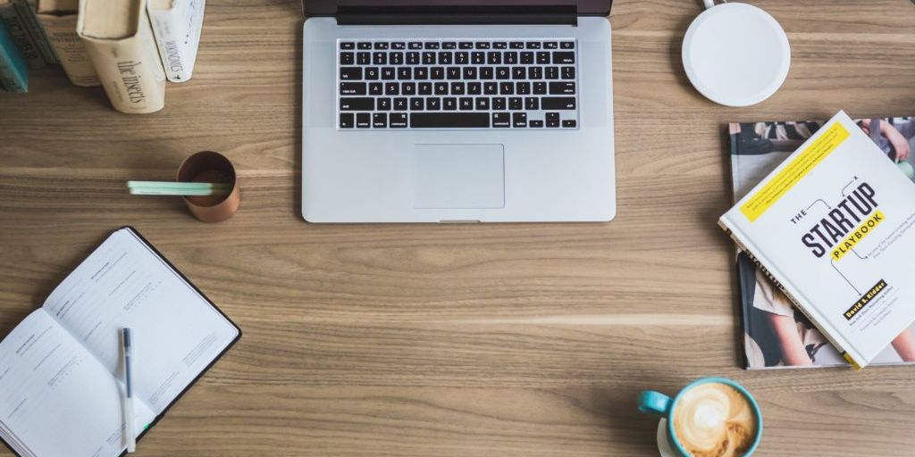 Macbook pro on desk showing a clock