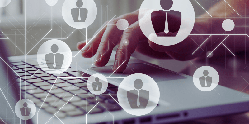 Person typing on a laptop with digital icons representing different examiner roles in an online marking system