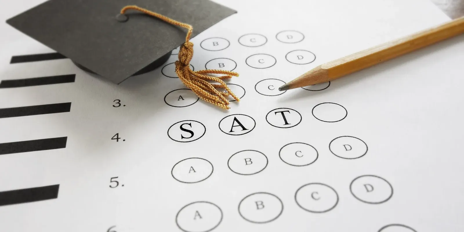 Multiple-choice test sheet marked SAT with a pencil and graduation cap symbolising a high-stakes summative assessment