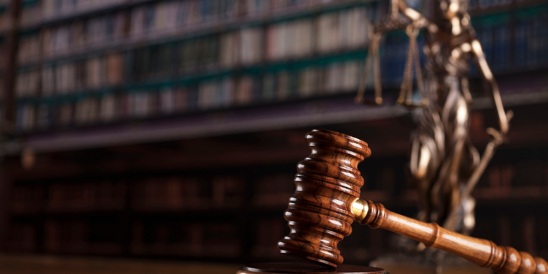 Gavel resting on its block in a law library