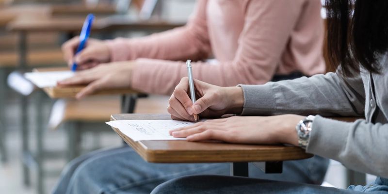 Students writing an exam in a classroom