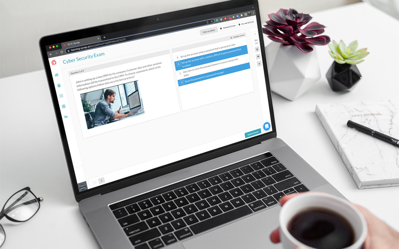 Person taking an exam on Synap platform using MacBook Pro while holding a coffee.