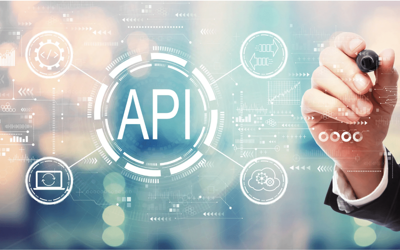 Hand drawing over a digital interface with the word API in the center, surrounded by icons representing cloud computing, data syncing, and system integration.