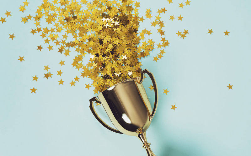 Trophy with stars falling out of the top