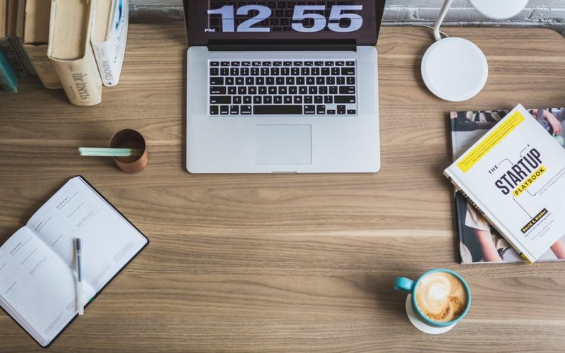 Macbook pro on desk showing a clock