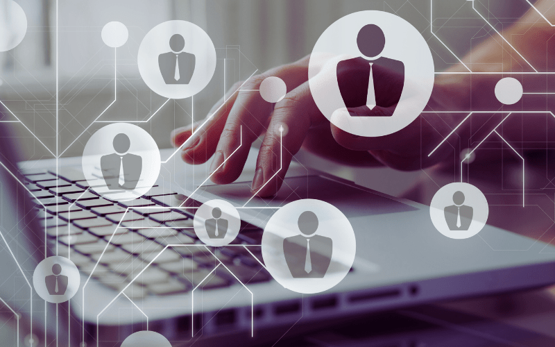 Person typing on a laptop with digital icons representing different examiner roles in an online marking system