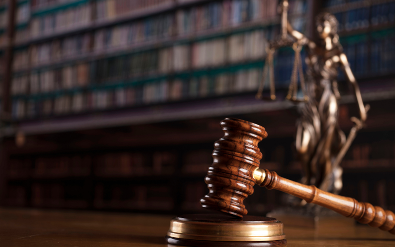 Gavel resting on its block in a law library
