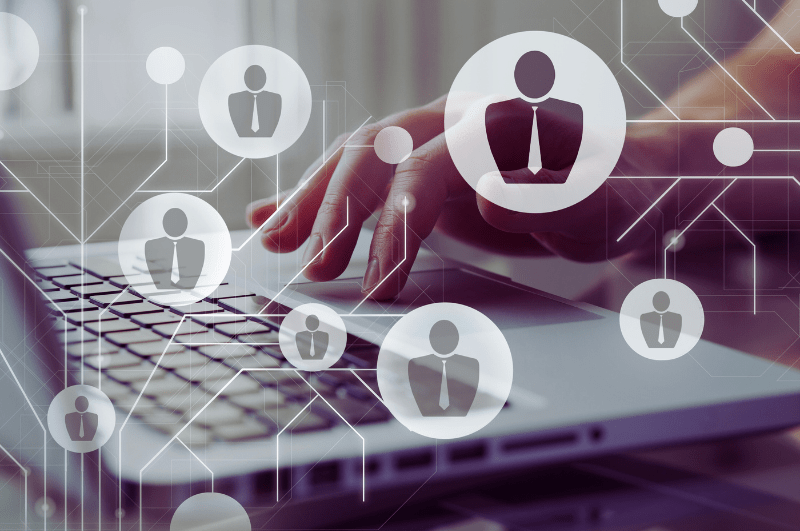 Person typing on a laptop with digital icons representing different examiner roles in an online marking system